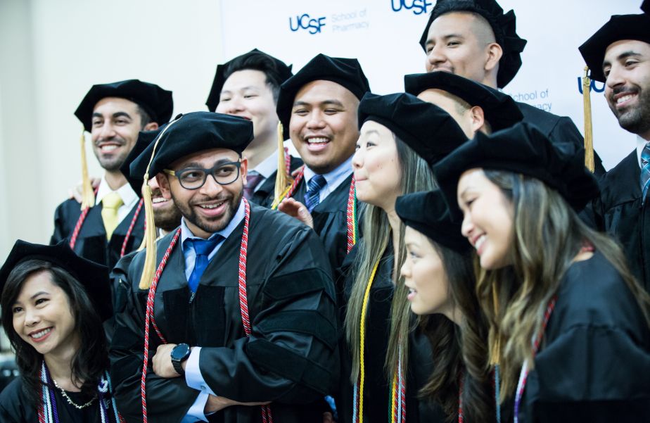 many graduates pose for a group photo.