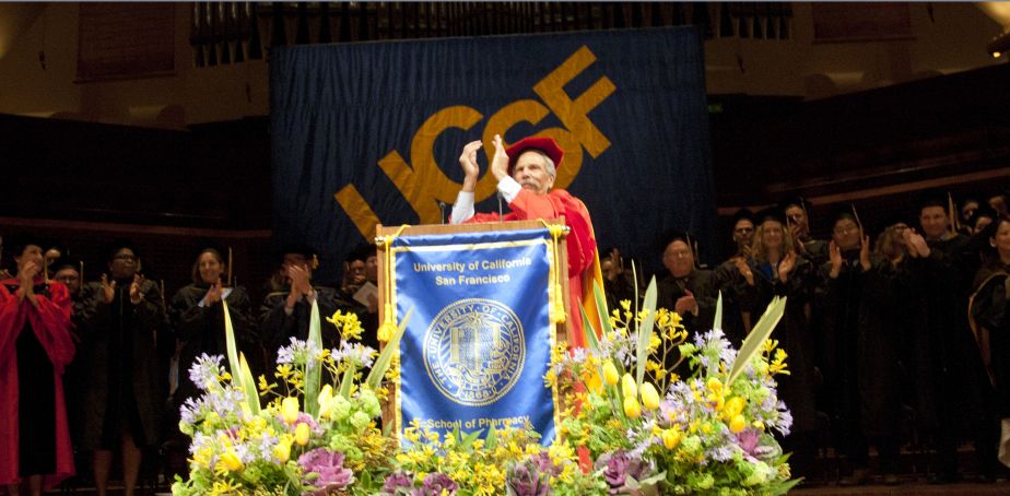 Faculty applauds from stage