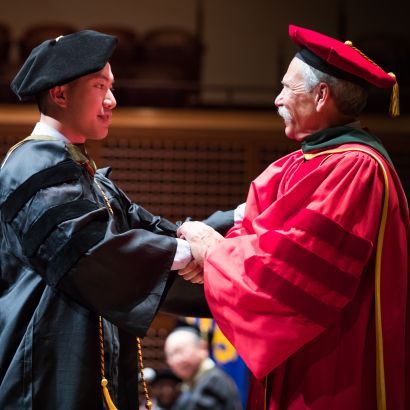 graduate and Guglielmo dressed in regalia