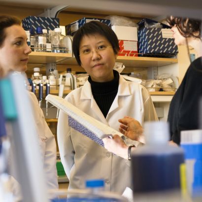 women in a laboratory discuss a project.