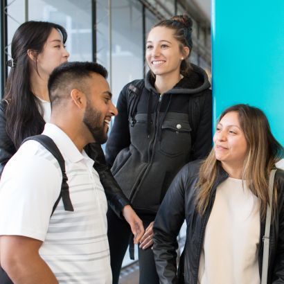 Students in front of a pillar with a &quot;UCSF&quot; banner