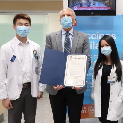 Guglielmo holds the official proclamation of Pharmacist Day in San Francisco while surrounded by PharmD students.