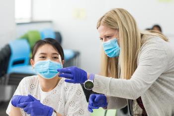 Clinard instructing student with vaccination technique
