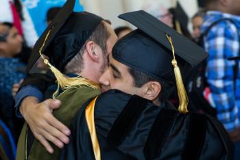 graduates hugging