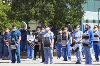Health care workers standing at a rally