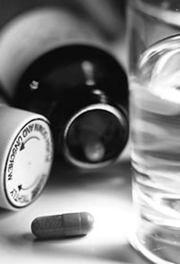 medication bottles with a pill and a glass of water