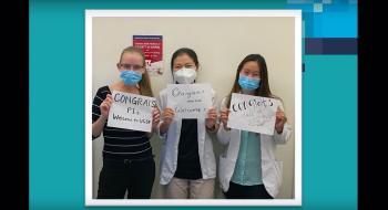 Masked students hold signs that read "Congrats Class of 2023."